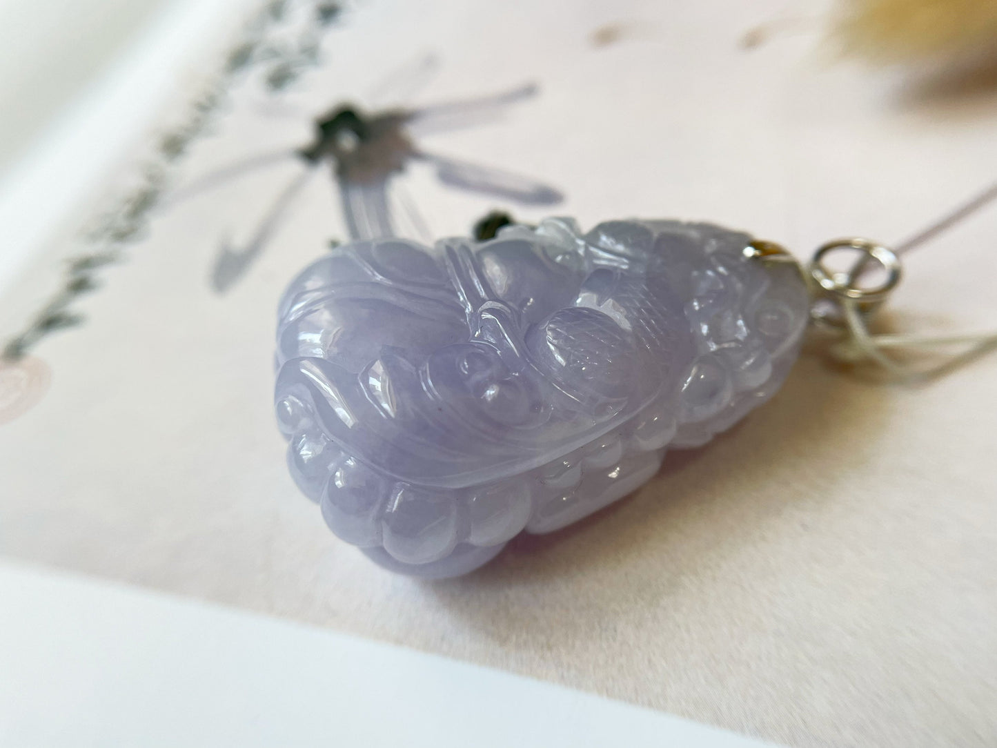 Exquisite lavender Qilin jadeite carved from 100% natural, untreated Type-A jadeite, featuring 8 sparkling diamonds set in 18K white gold. Dimensions: width 29.2 mm, height 51.6 mm, thickness 19.6 mm; total weight 218.54 ct. The icy texture and intricate carving symbolize good luck, prosperity, and happiness in Asian mythology, making it a meaningful accessory for any occasion.