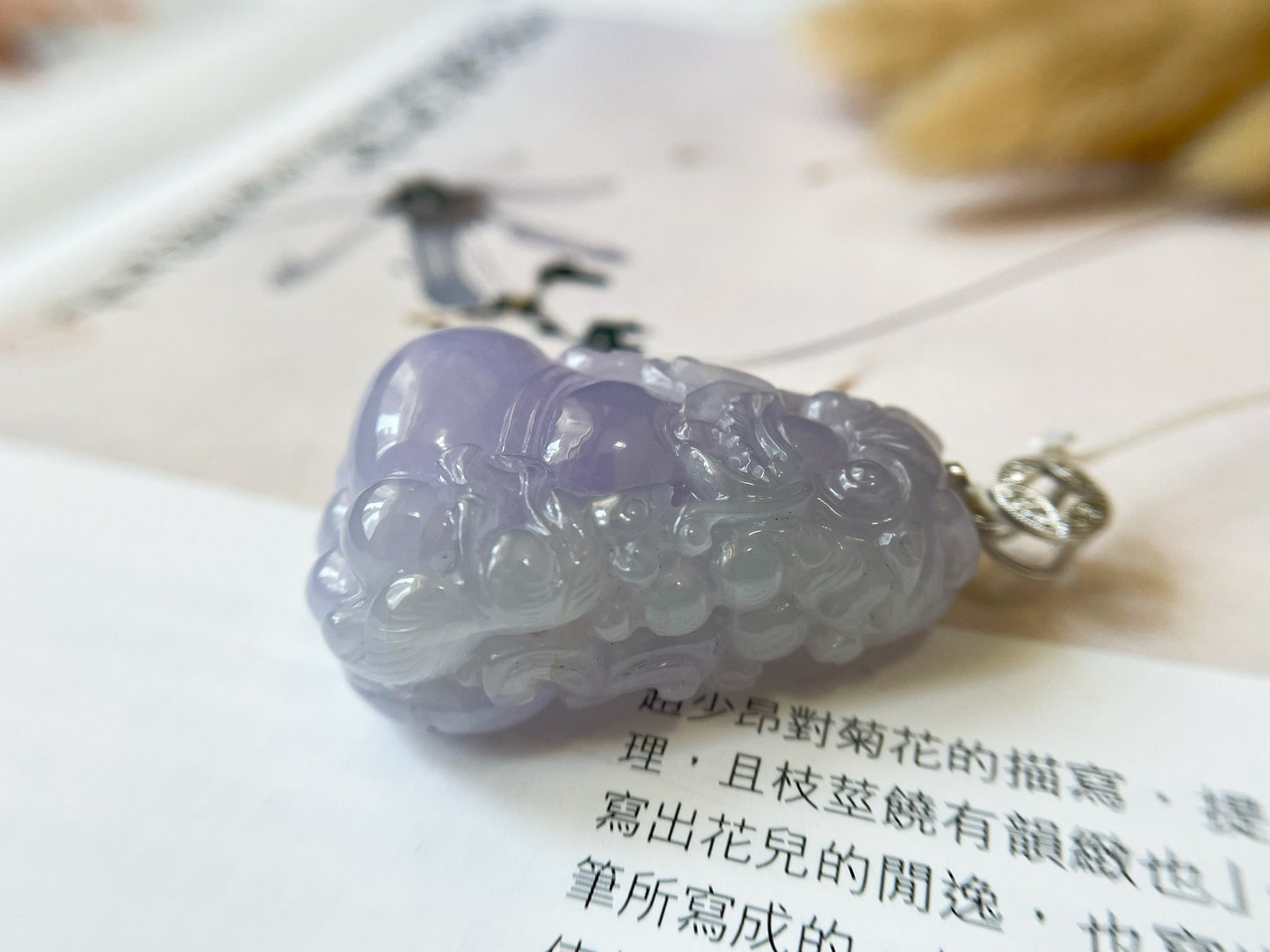 Exquisite lavender Qilin jadeite carved from 100% natural, untreated Type-A jadeite, featuring 8 sparkling diamonds set in 18K white gold. Dimensions: width 29.2 mm, height 51.6 mm, thickness 19.6 mm; total weight 218.54 ct. The icy texture and intricate carving symbolize good luck, prosperity, and happiness in Asian mythology, making it a meaningful accessory for any occasion.