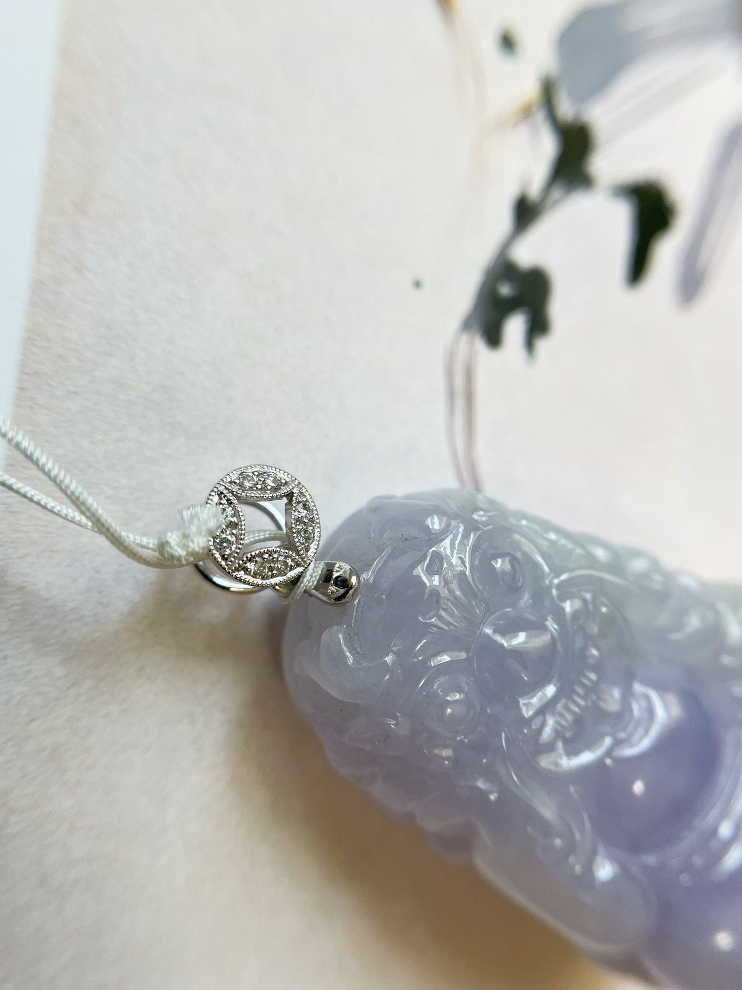 Exquisite lavender Qilin jadeite carved from 100% natural, untreated Type-A jadeite, featuring 8 sparkling diamonds set in 18K white gold. Dimensions: width 29.2 mm, height 51.6 mm, thickness 19.6 mm; total weight 218.54 ct. The icy texture and intricate carving symbolize good luck, prosperity, and happiness in Asian mythology, making it a meaningful accessory for any occasion.